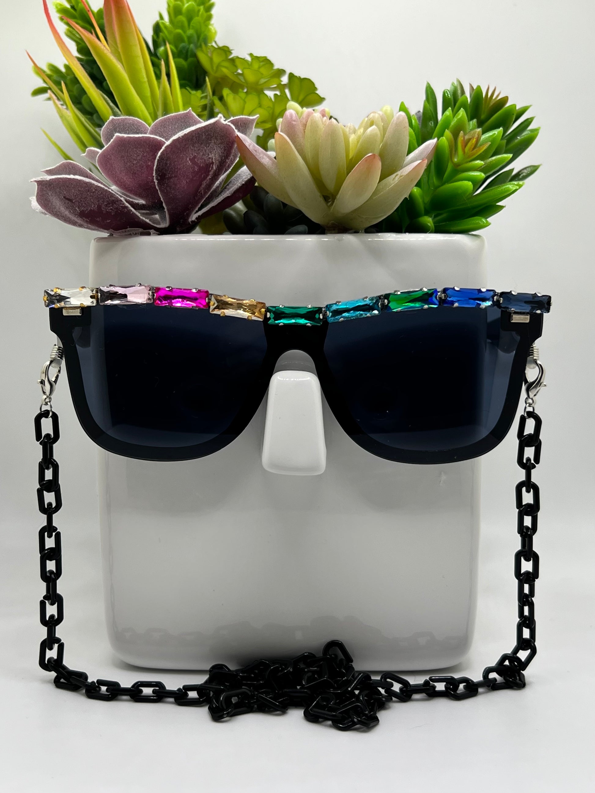 These dark aviators are topped with a rainbow of shimmering rhinestones and come with a removable eyewear chain in black.
